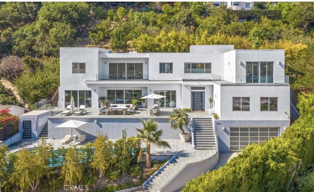 a front view of a house with swimming pool and sitting area