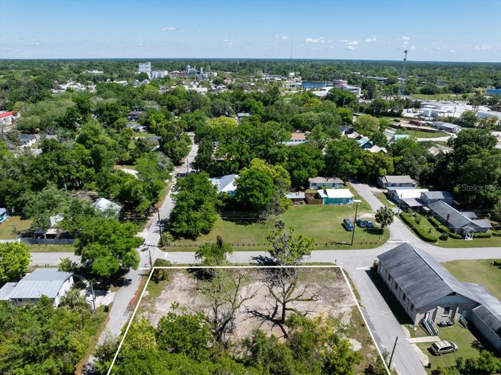 an aerial view of a residential houses with outdoor space and street view