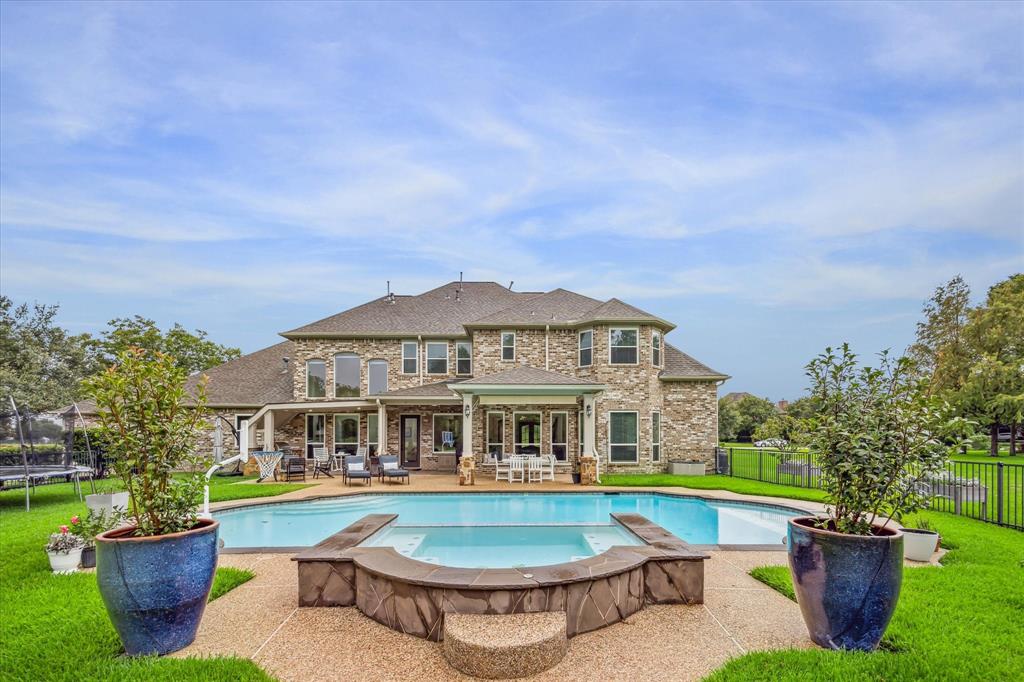 a view of a house with swimming pool and sitting area