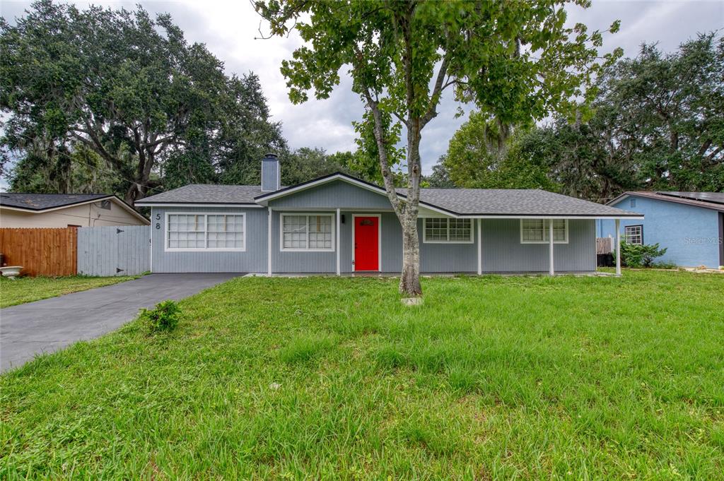 a view of an house with backyard space and garden