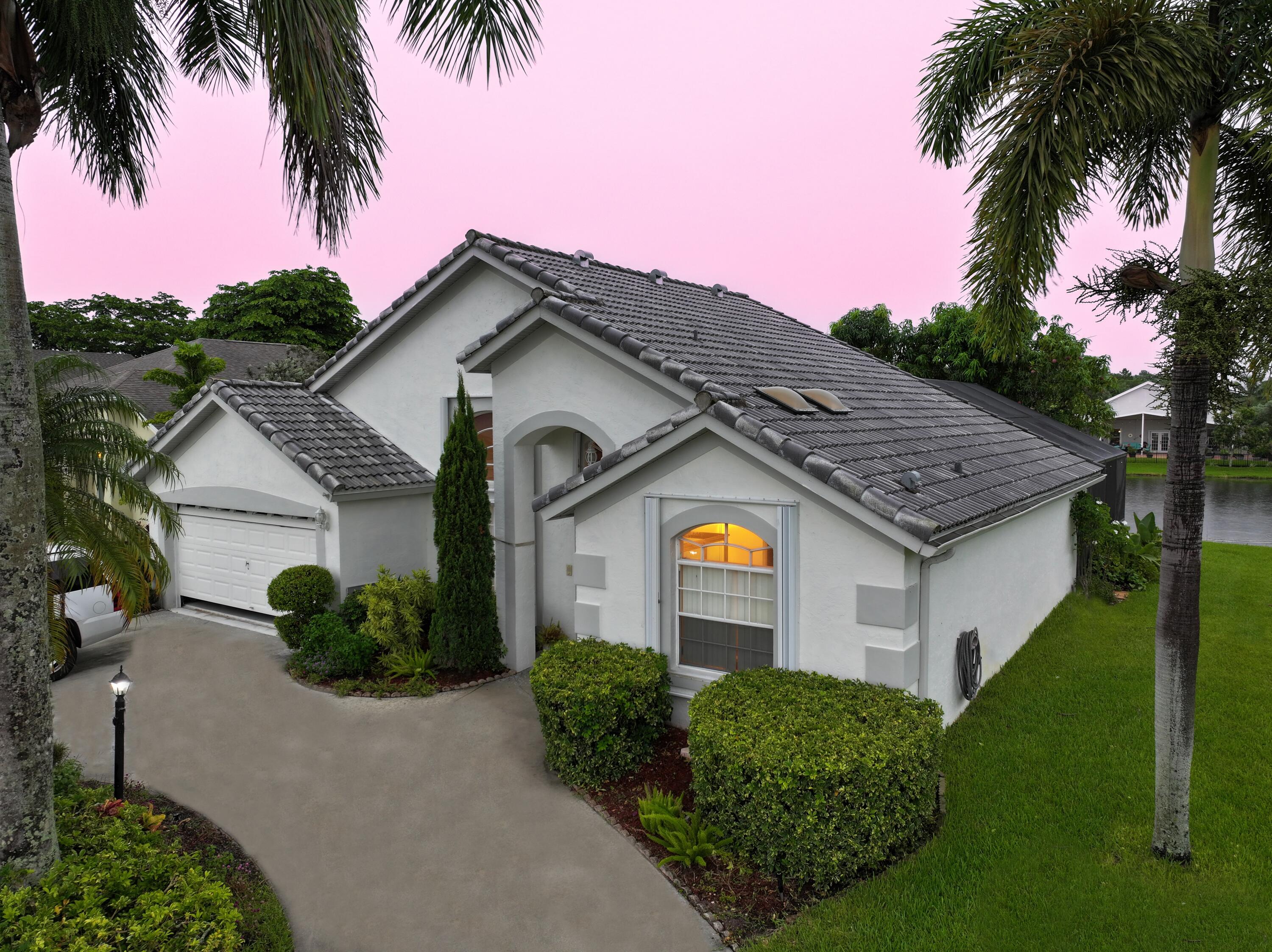 a view of a house with palm trees