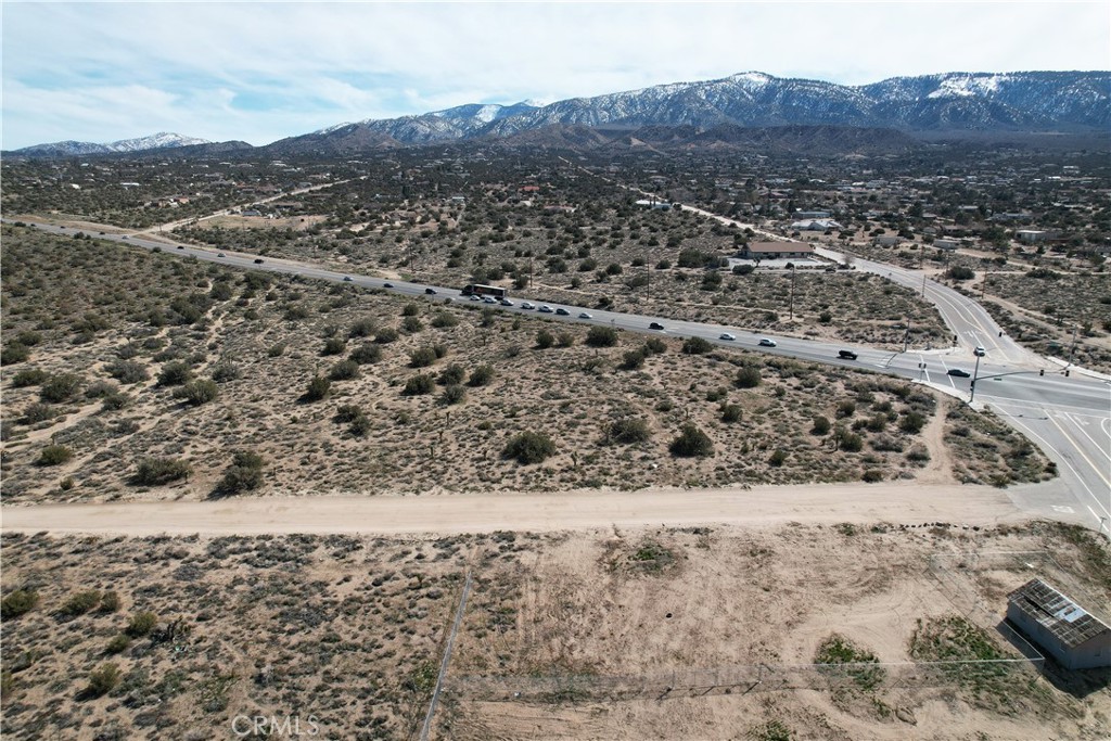 a view of a field with mountains in the background