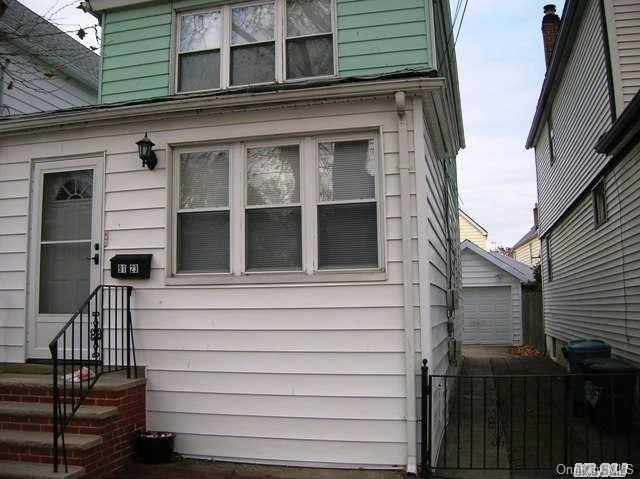 View of side of home featuring a garage and an outdoor structure