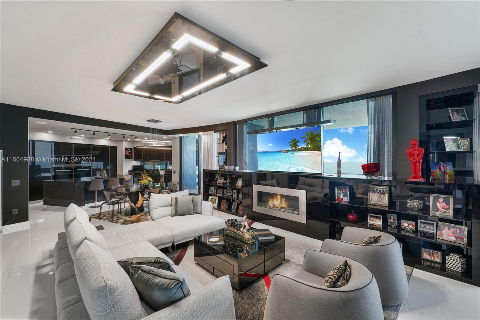 a living room with fireplace furniture and a large window