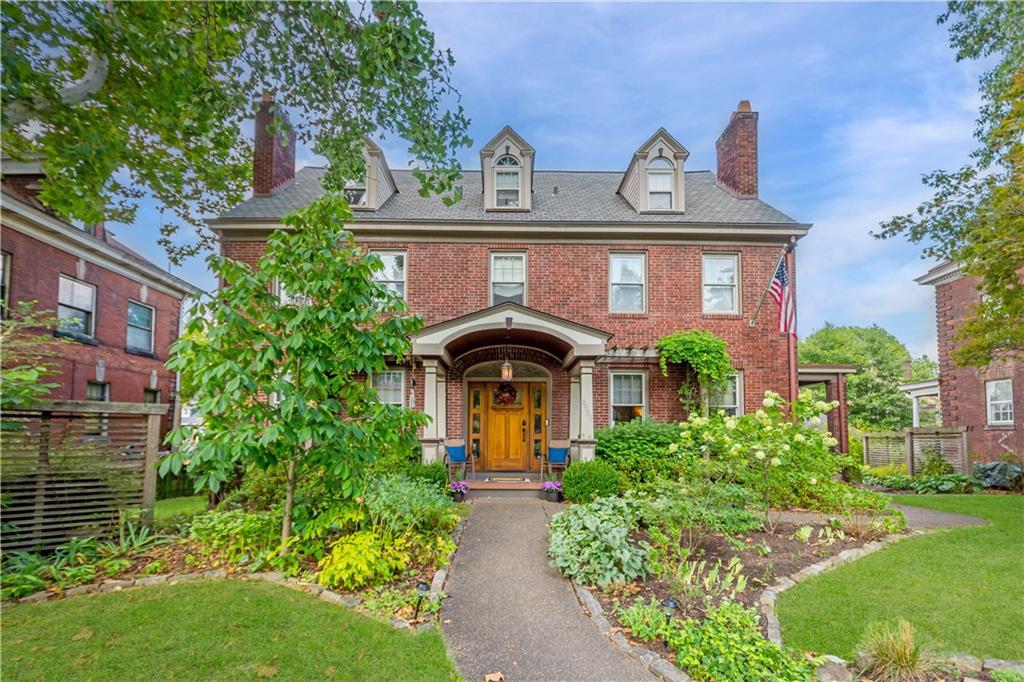 a front view of a house with garden