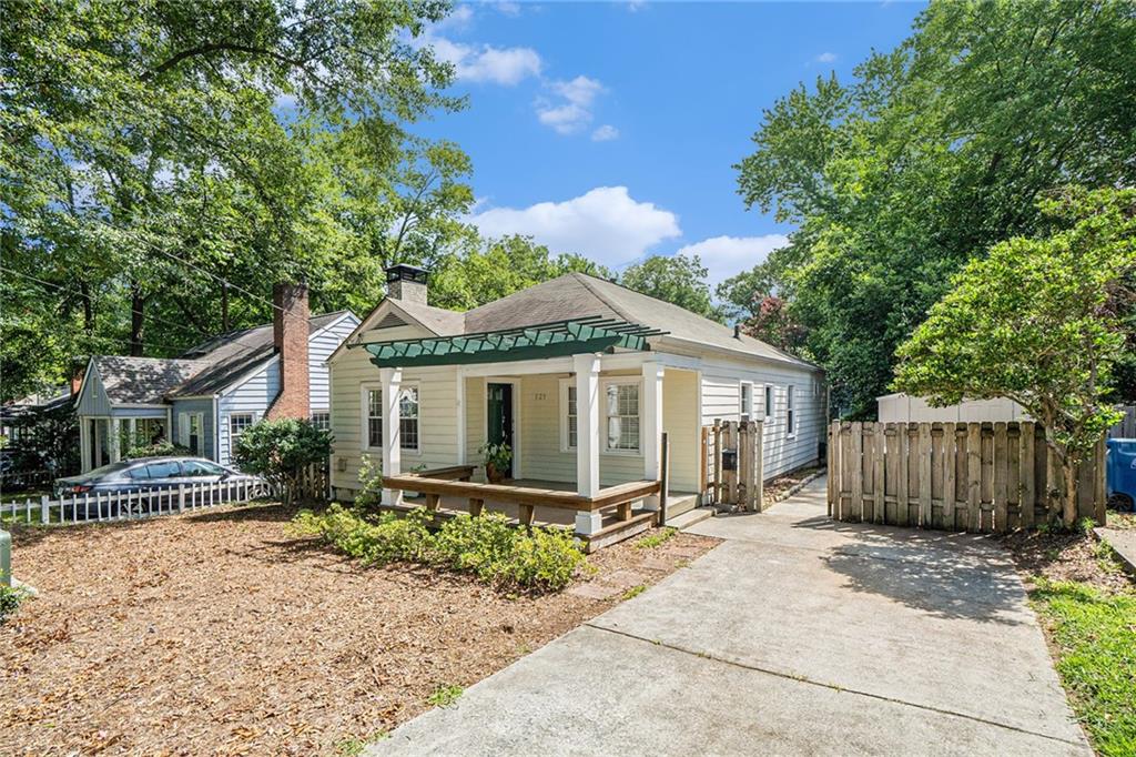 a front view of a house with a garden and yard