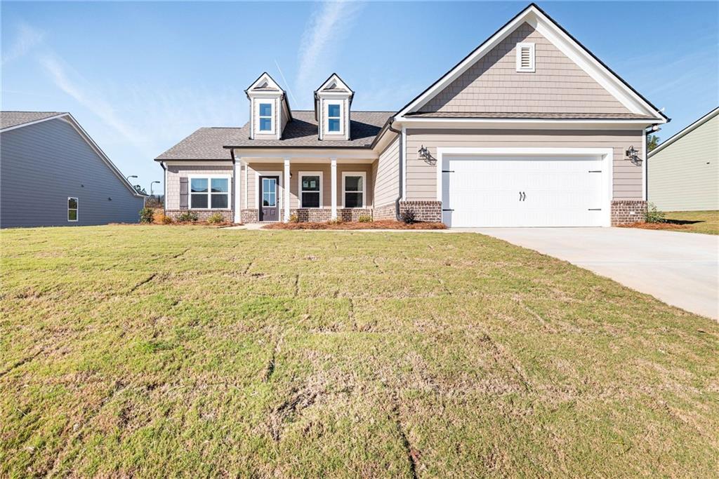 a front door view of a house with a yard