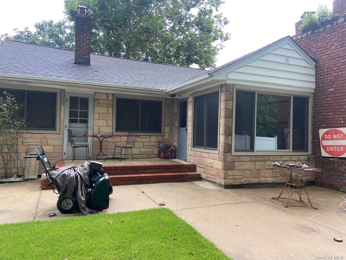 a view of a house with a patio and a garden