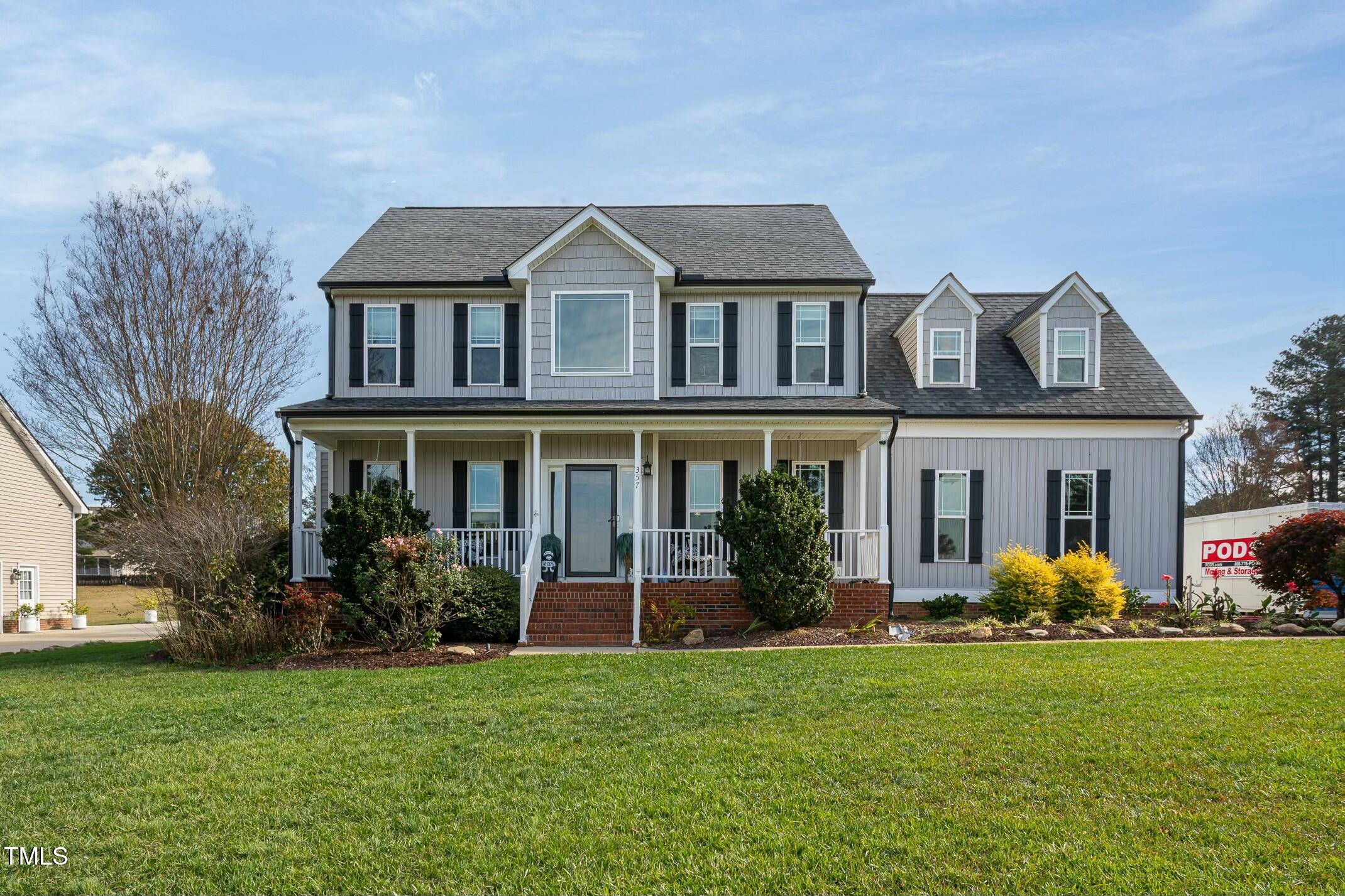 a front view of house with yard and green space