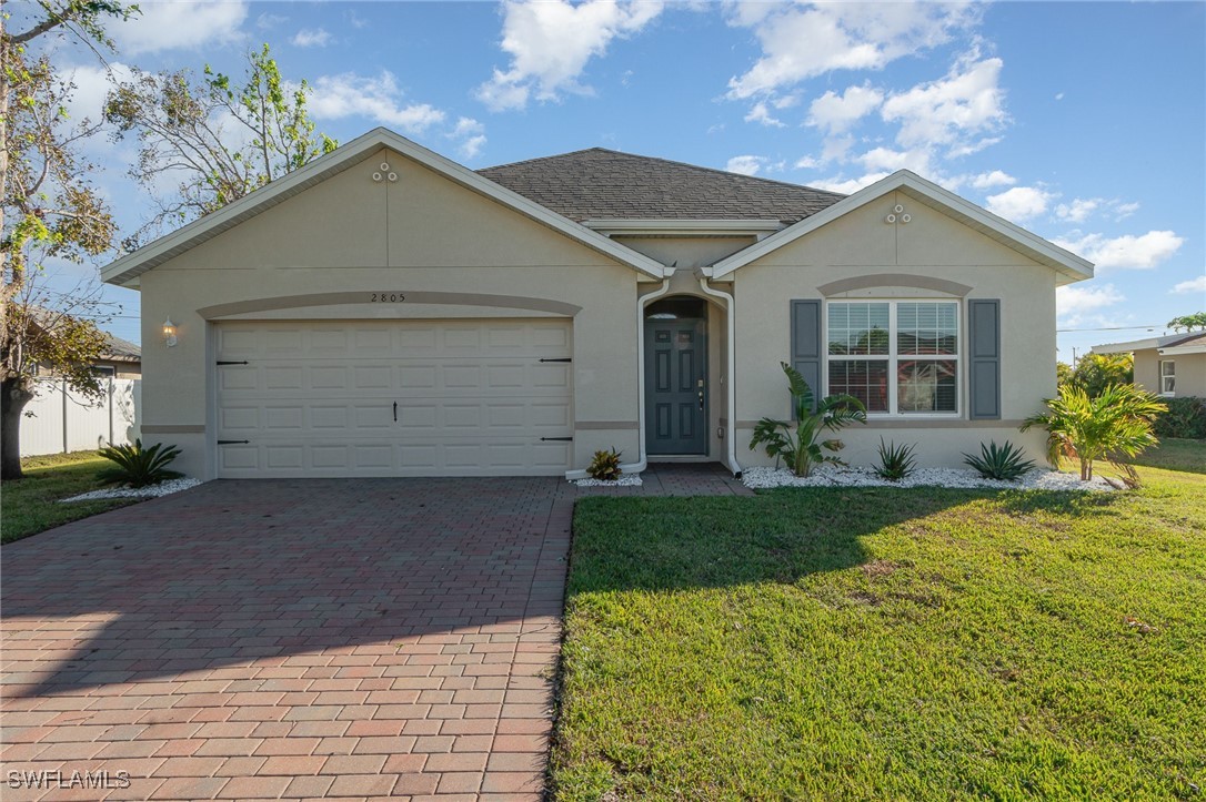 a front view of house with yard and green space