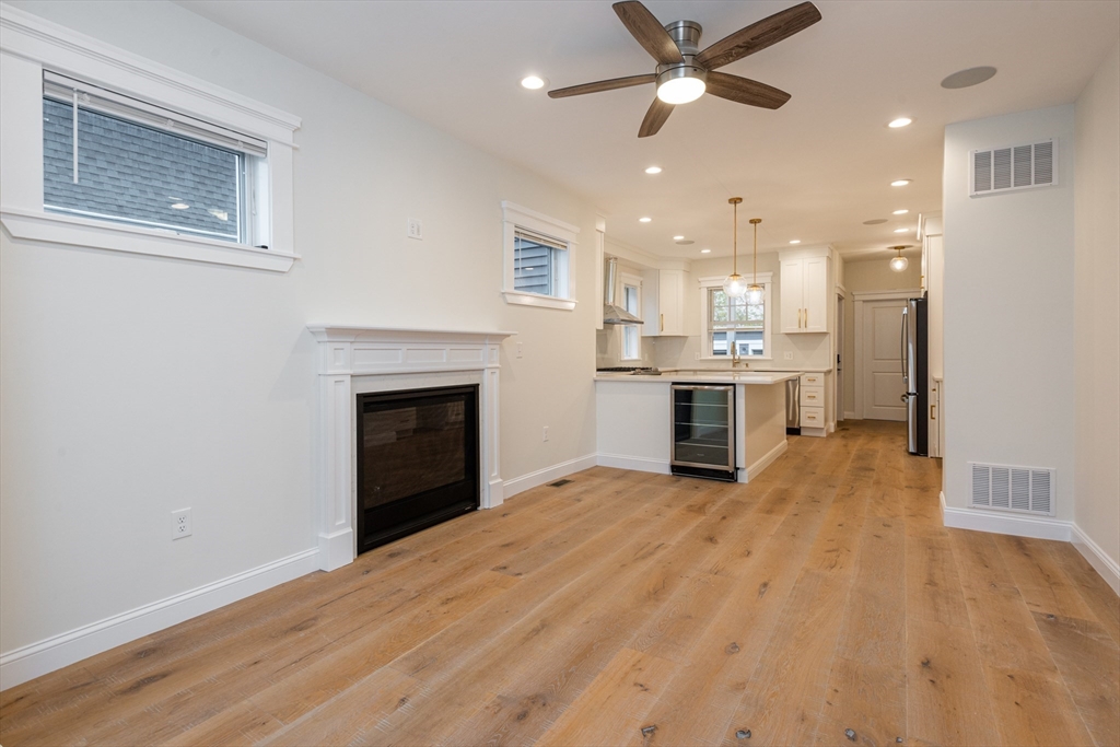 a view of a kitchen with a sink and a fireplace