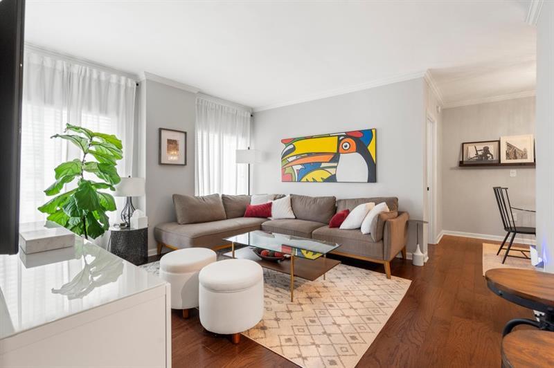 a living room with furniture kitchen view and a window