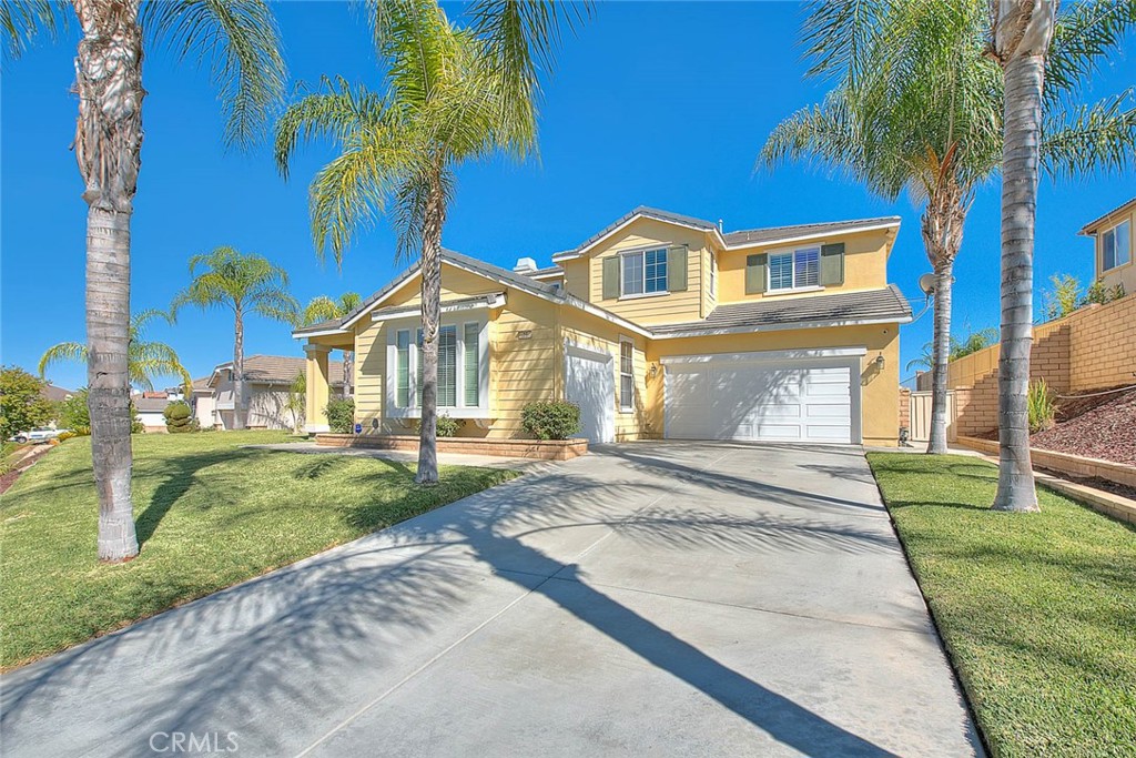 a front view of a house with a garden and patio