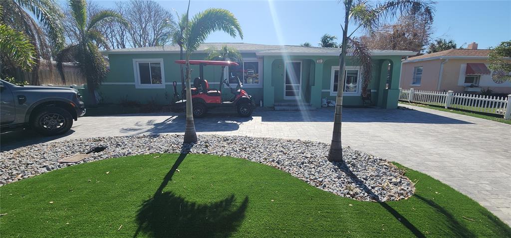 a view of a house with a backyard