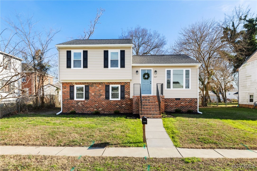 Tri-level home with a front lawn