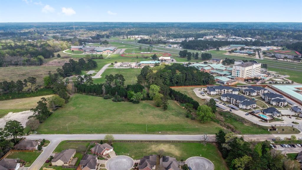 an aerial view of a houses with yard