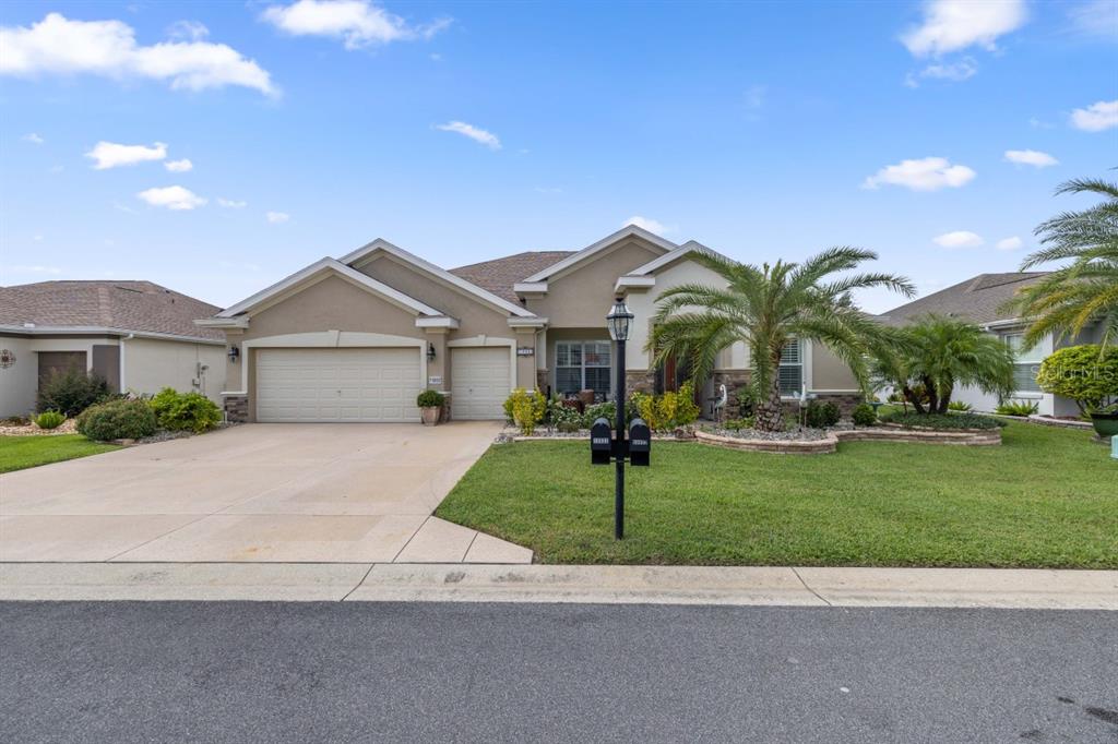 a front view of a house with a yard and garage