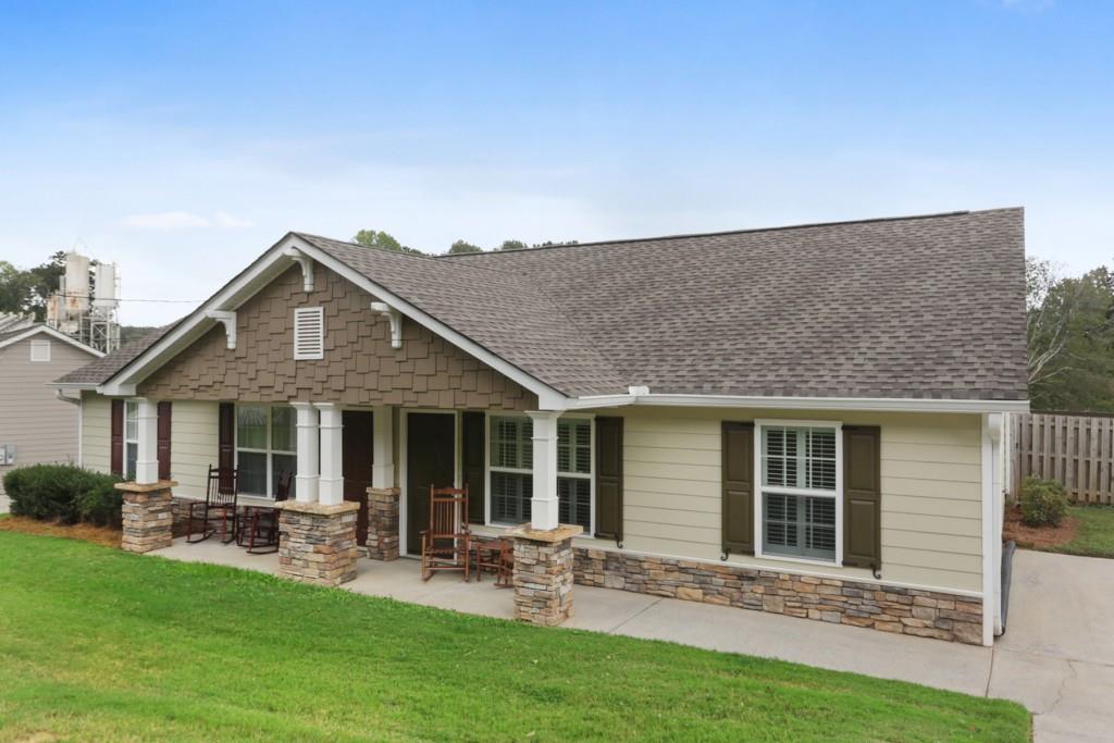 a front view of a house with patio and garden