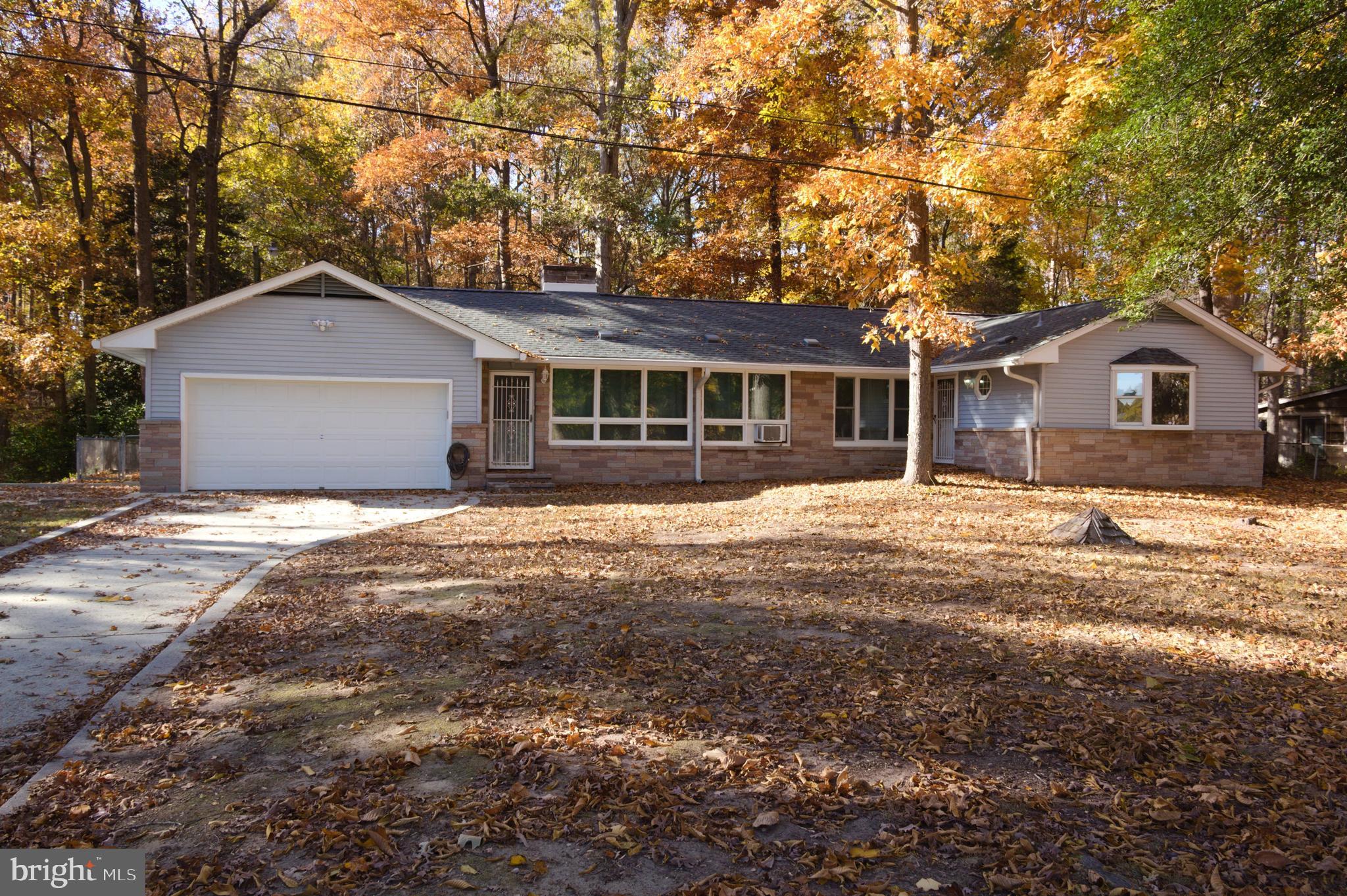 a front view of a house with a garden and yard