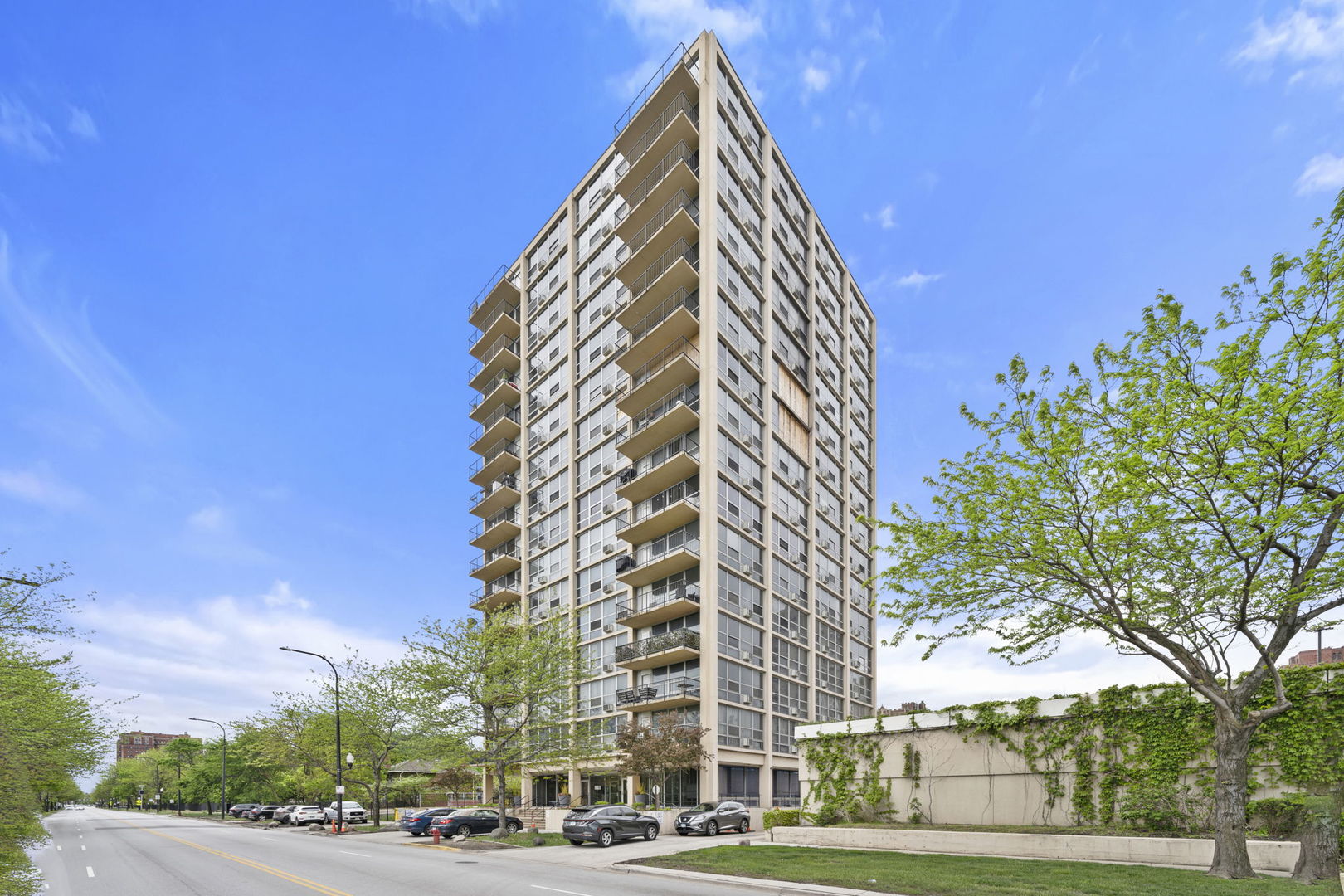 a view of a tall building next to a road