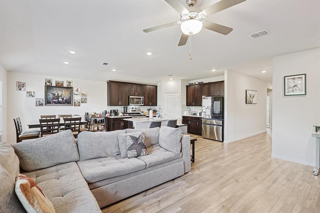 Living room featuring ceiling fan and light wood-type flooring