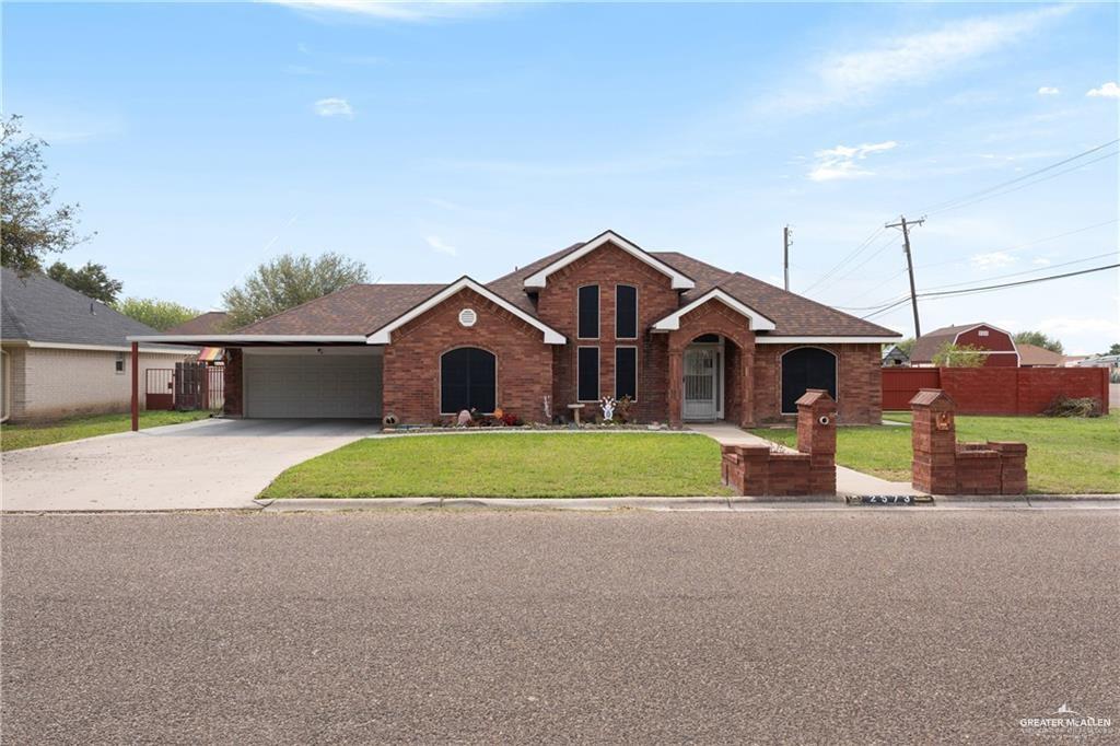 a front view of house with yard and green space