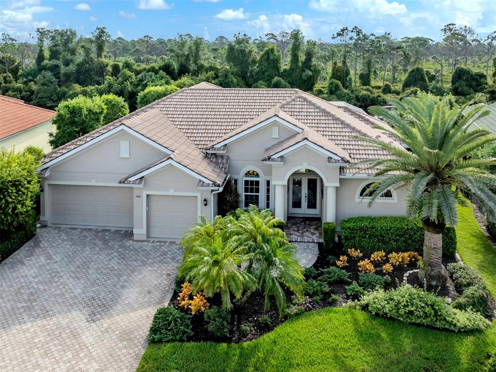 a aerial view of a house next to a yard