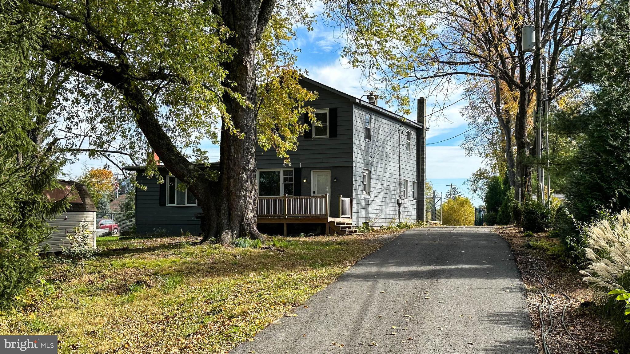 a view of a brick house with a large tree