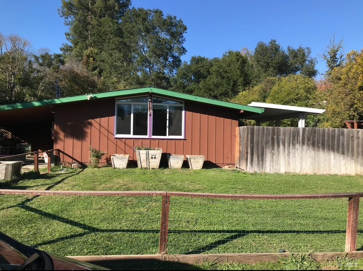 a view of a wooden house with a yard