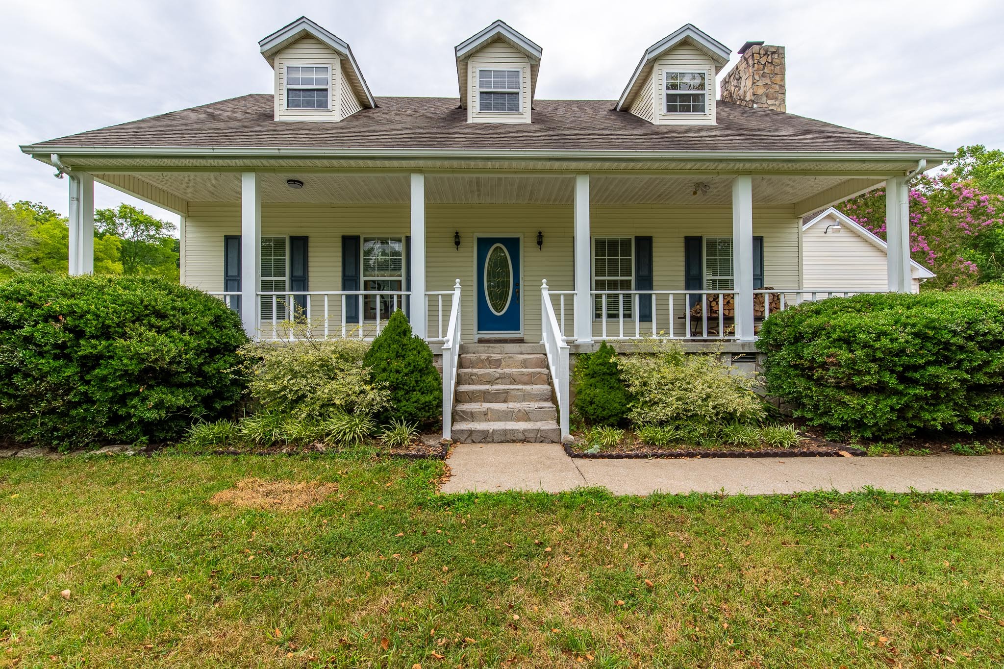 a front view of a house with garden