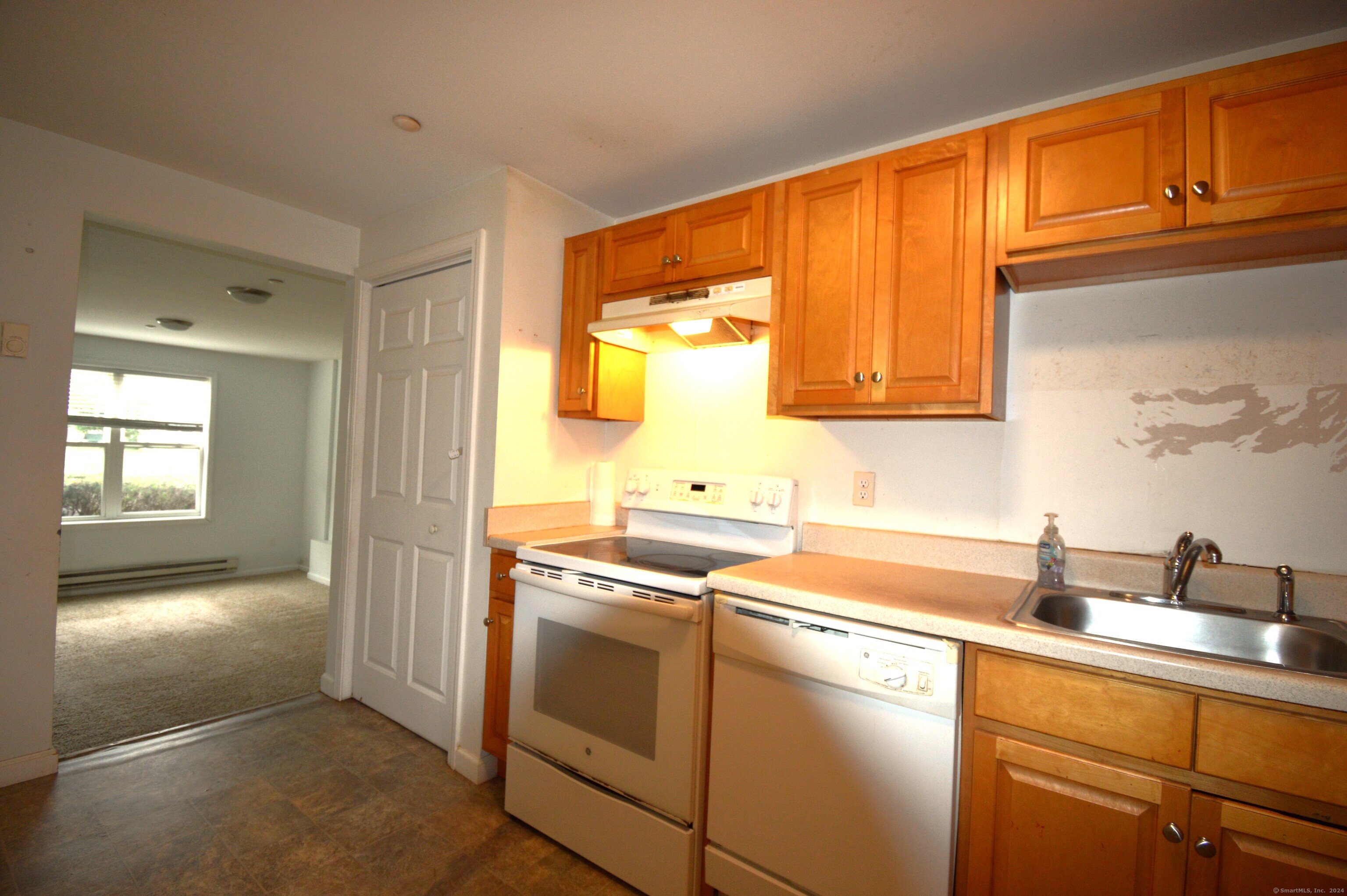 a kitchen with stainless steel appliances granite countertop a sink and a cabinets