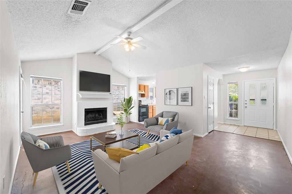 a living room with furniture a fireplace and a flat screen tv