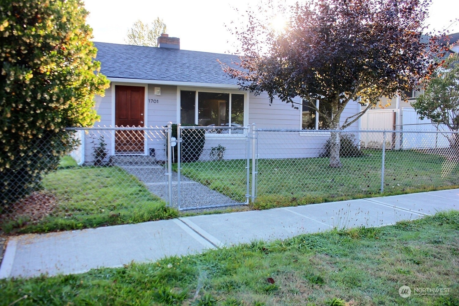 a view of a house with a yard and tree s