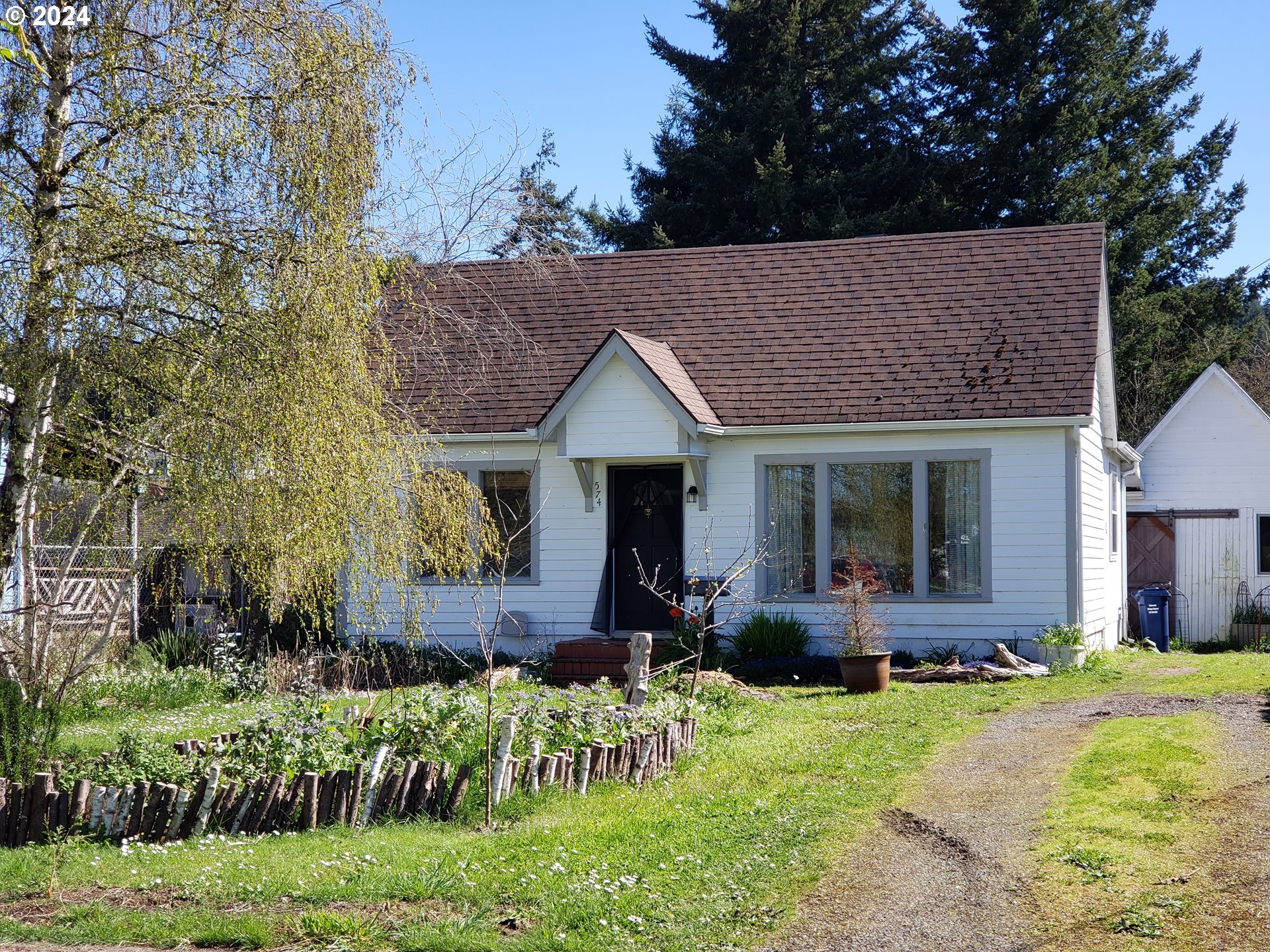 a front view of a house with a yard table and chairs