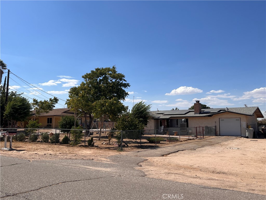 a view of a house with cars parked in front of it