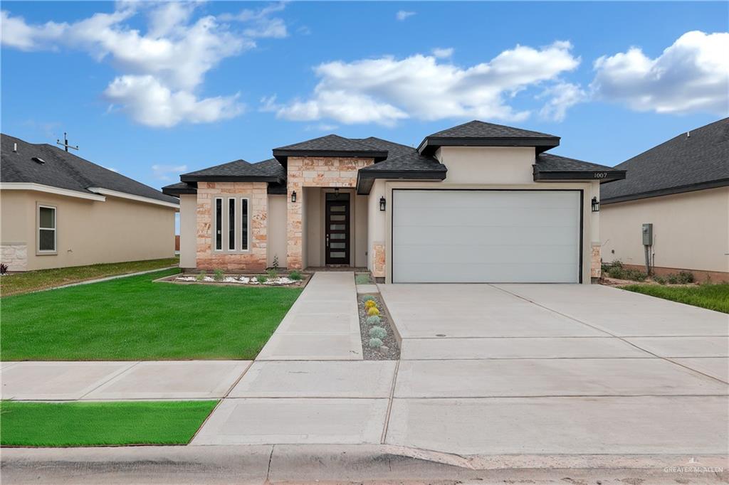 a front view of a house with a yard and garage