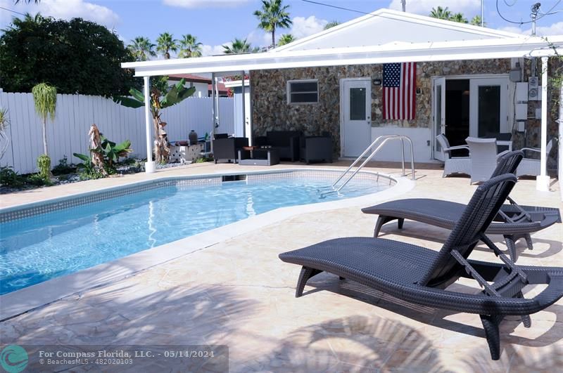 a view of a house with backyard porch and sitting area