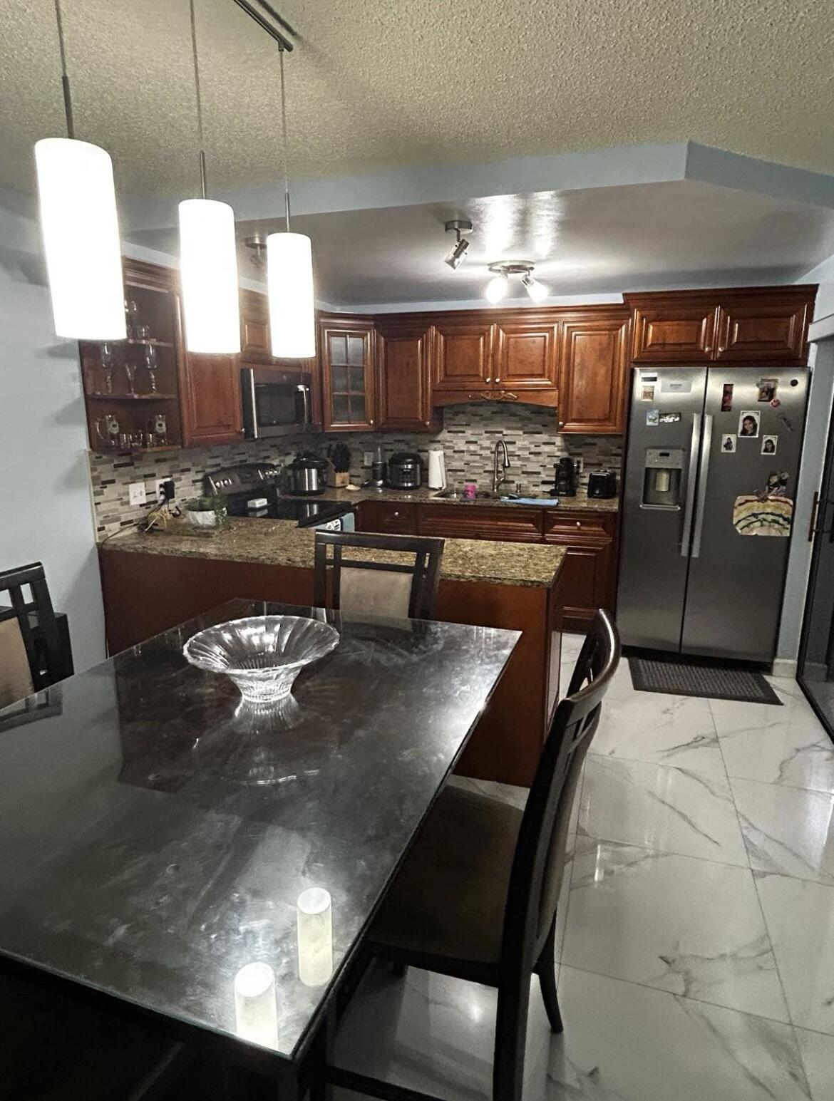 a kitchen with a table and chairs