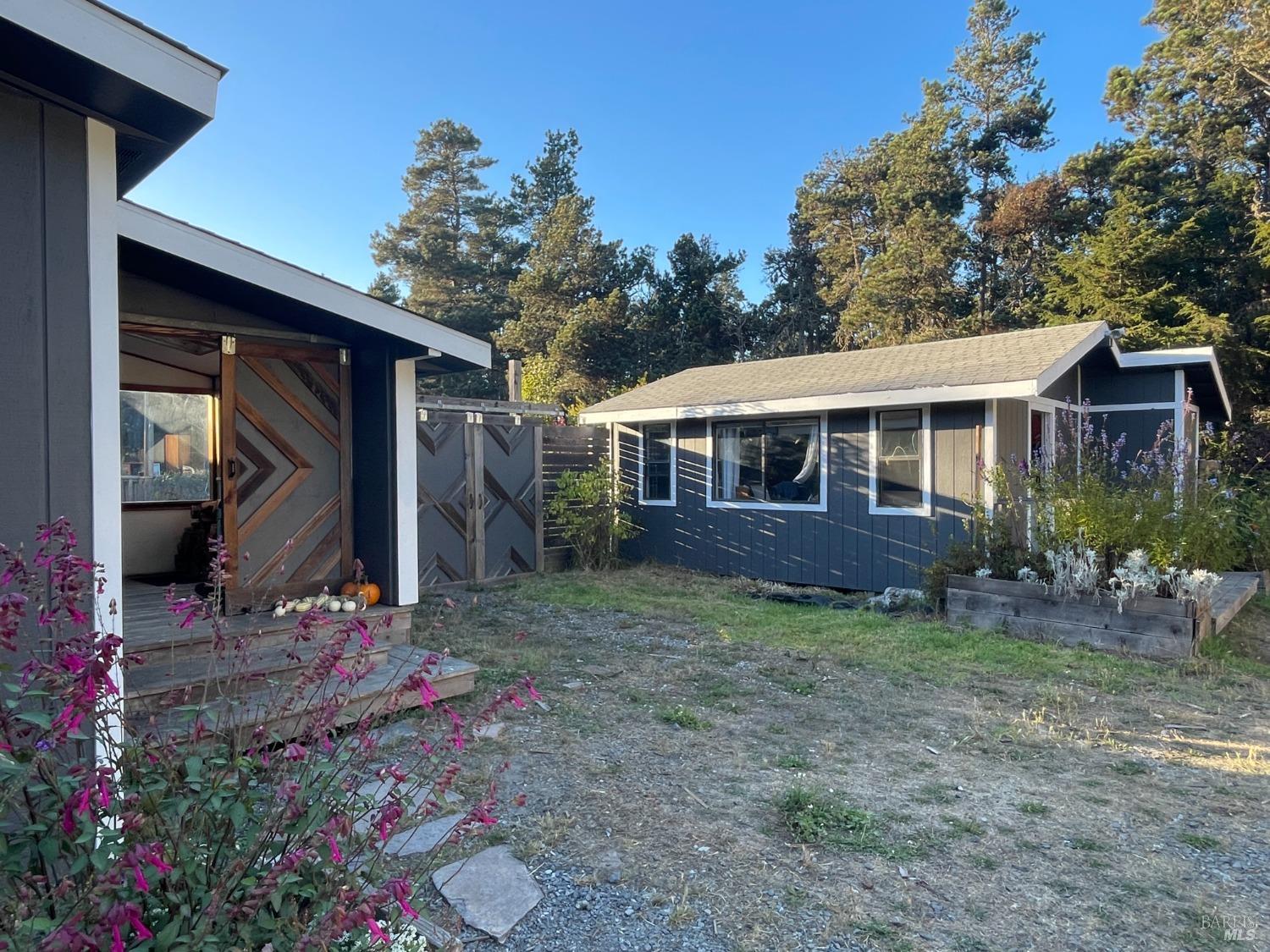 a view of a house with a yard and sitting area