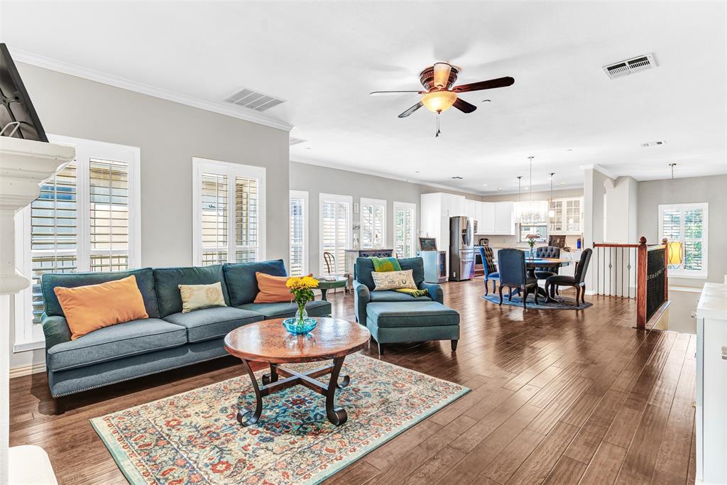 a living room with furniture kitchen view and a large window