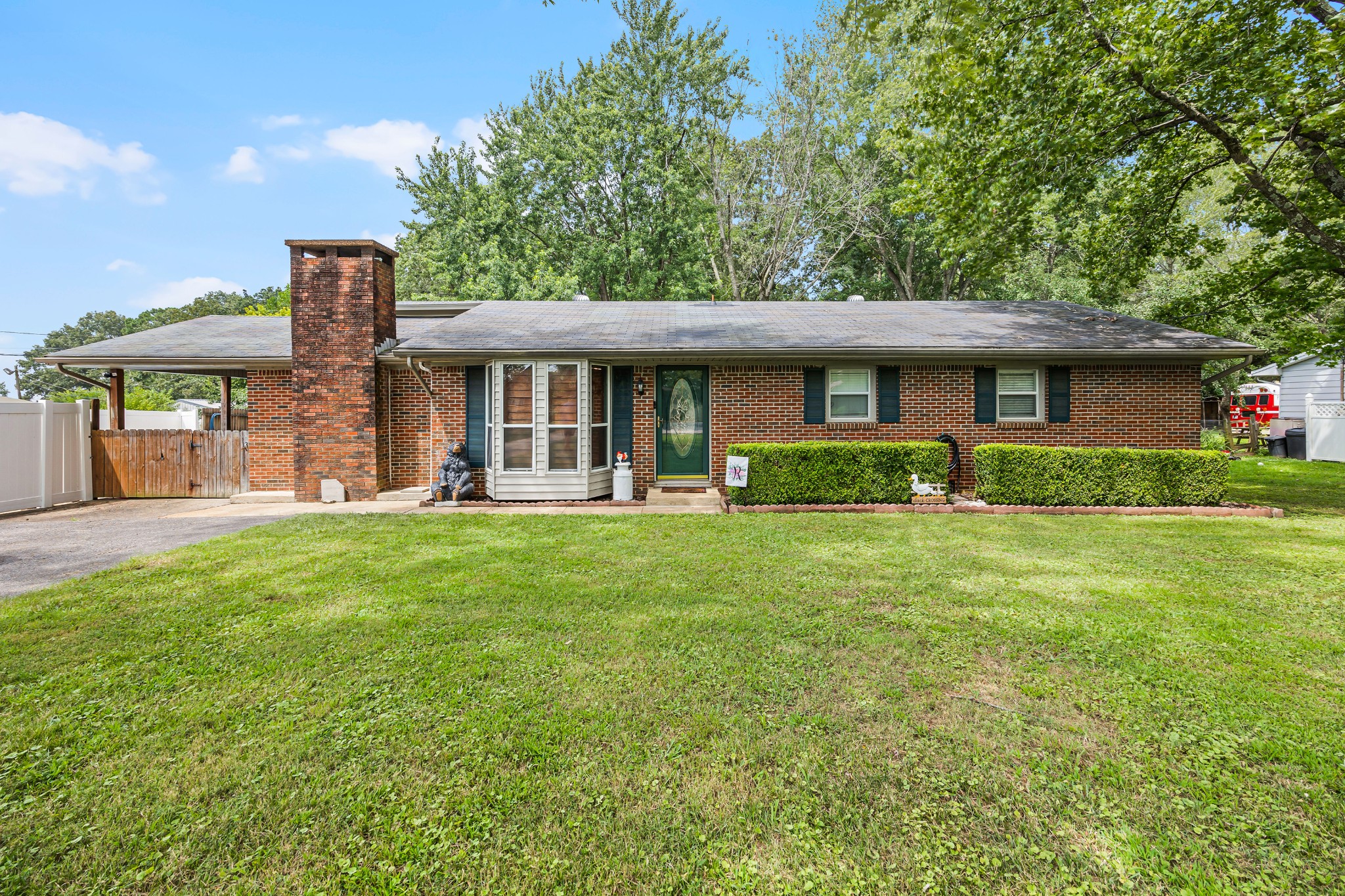 a front view of house with yard and green space