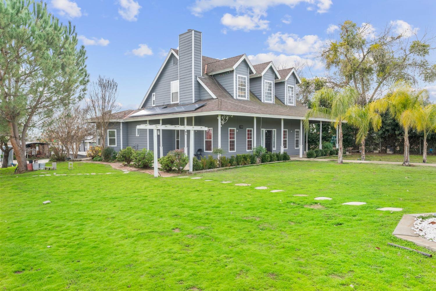 a front view of a house with a garden