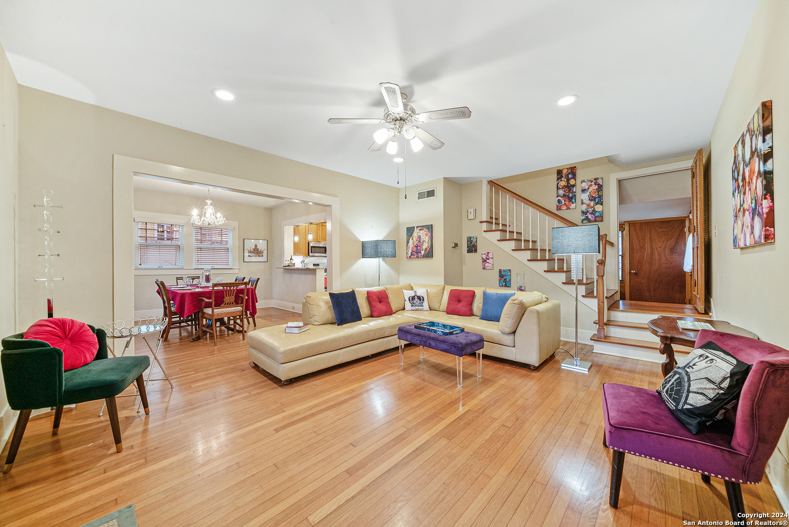 a living room with furniture and wooden floor