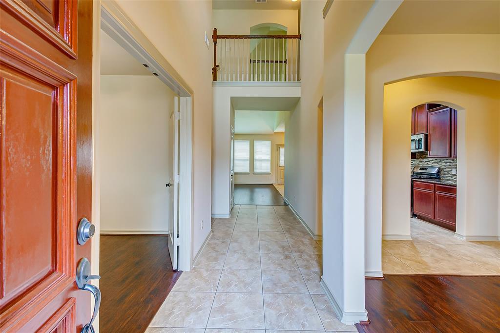 a view of a hallway with wooden floor and closet