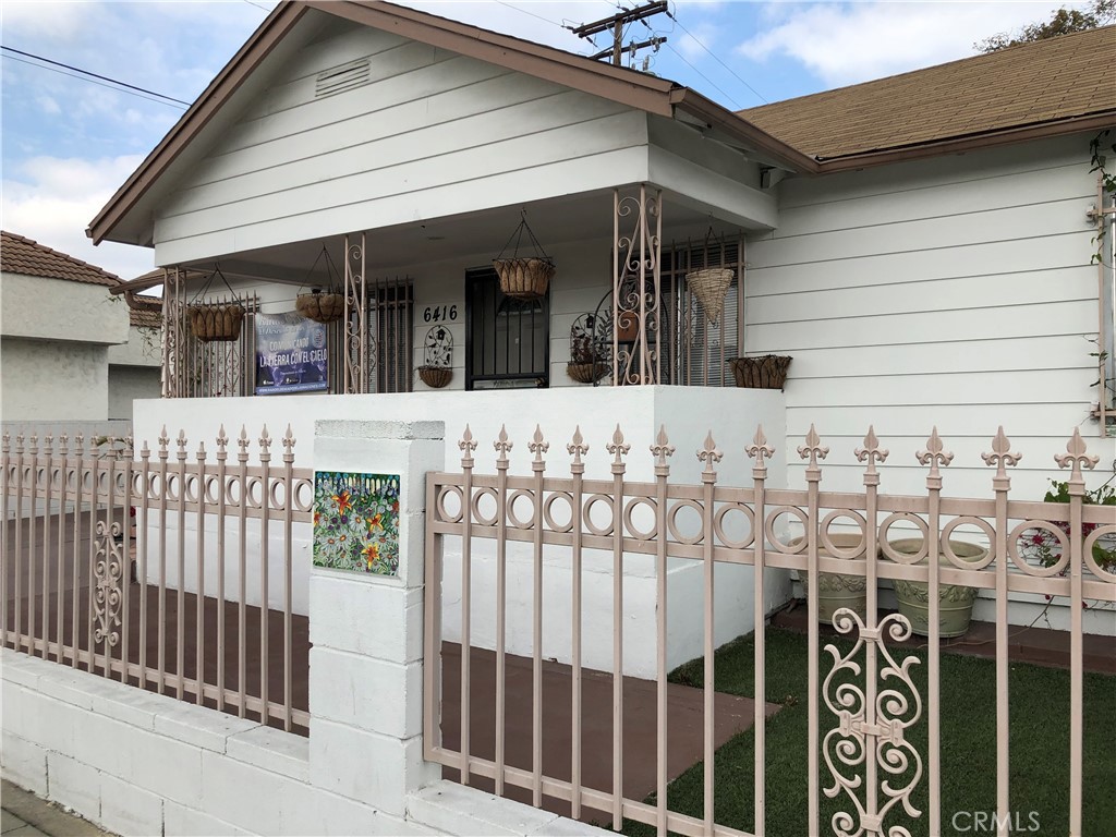 a view of a house with wooden fence