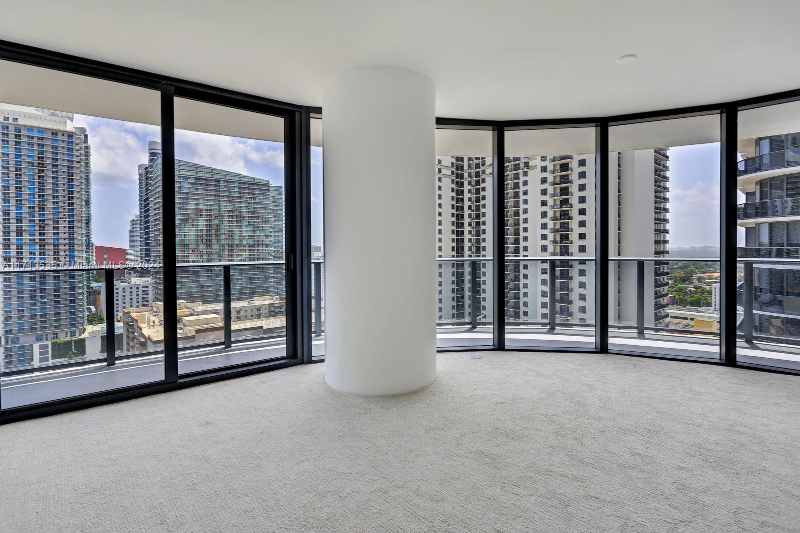 a view of an empty room with windows