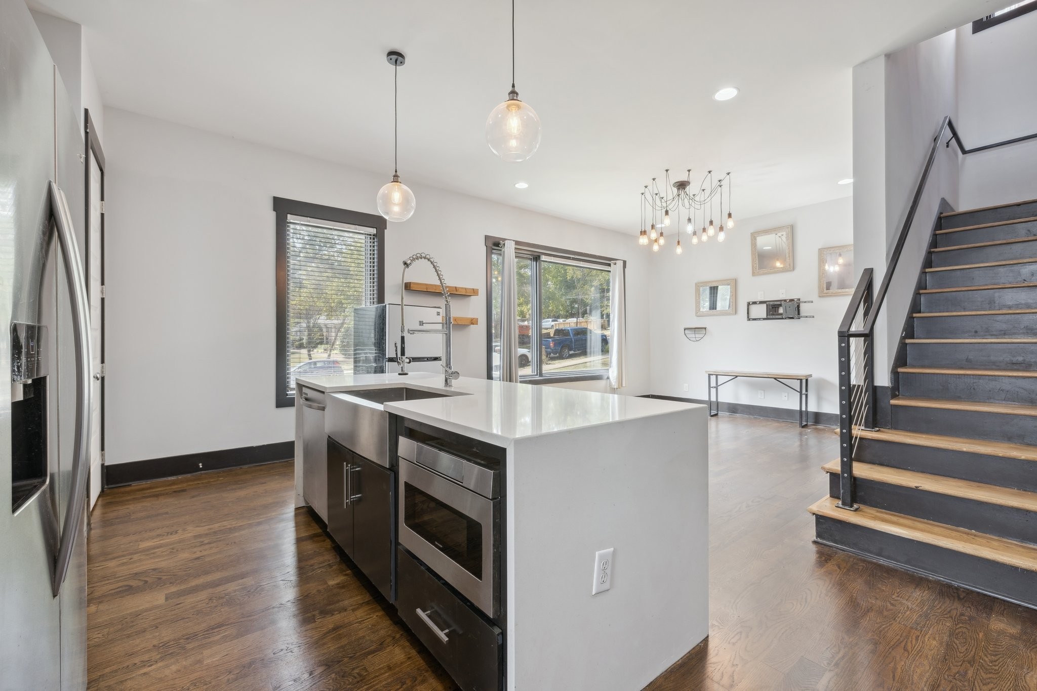 a kitchen with stove and wooden floor