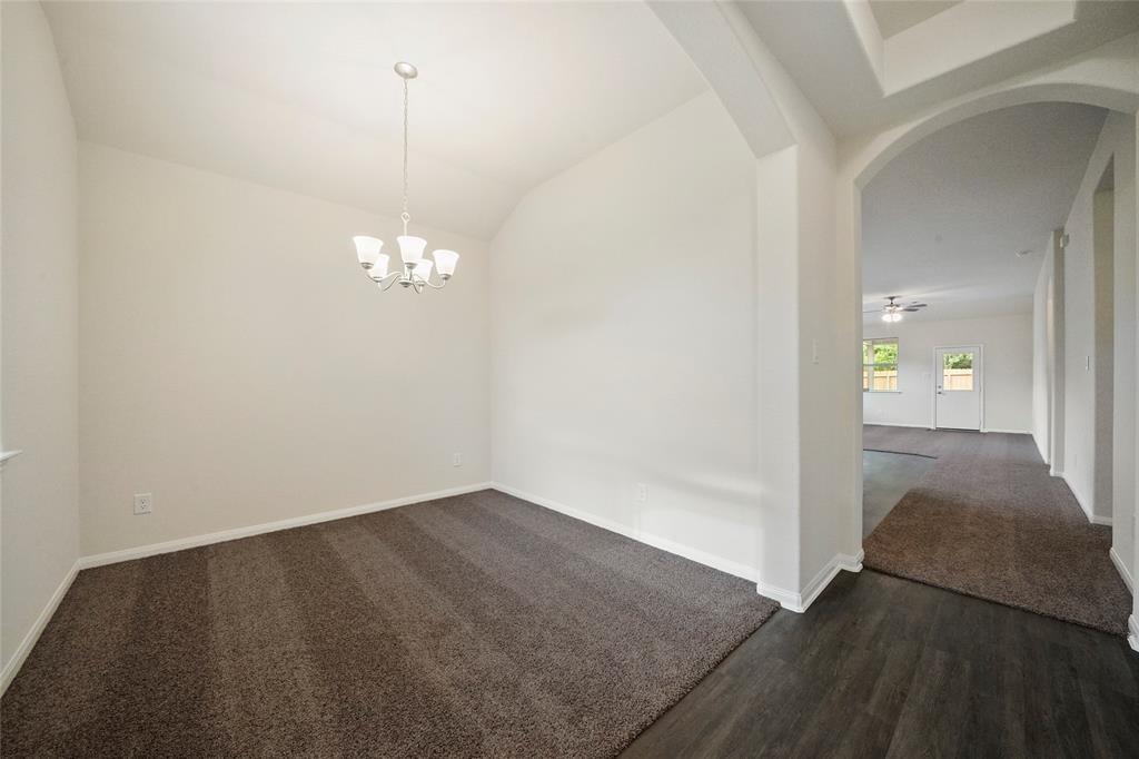 a view of a chandelier in big room and empty room