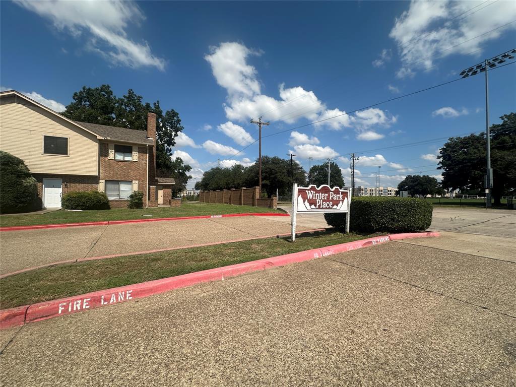 a front view of a house with a yard and road