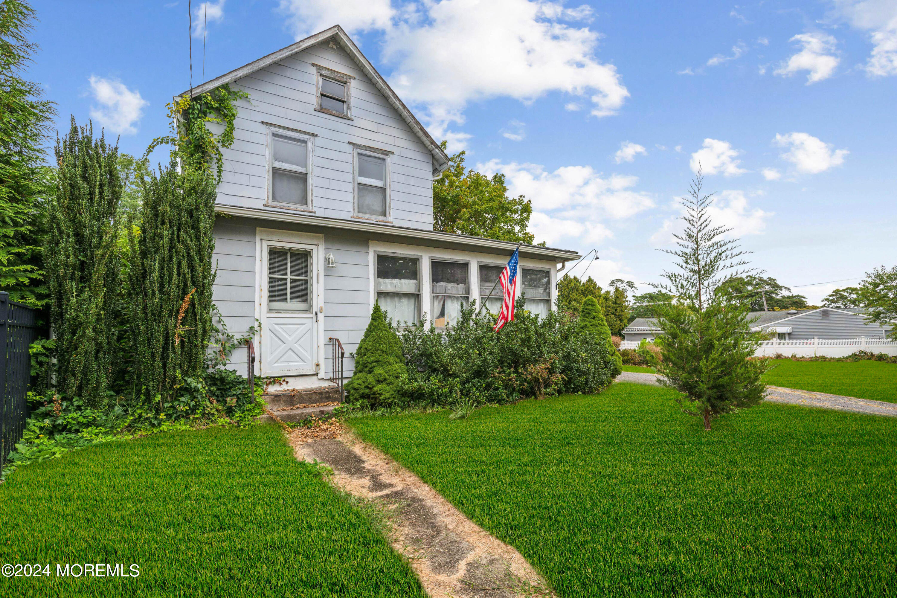 a front view of house with yard and green space